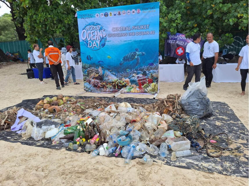 Beach clean up group with collected marine trash bags